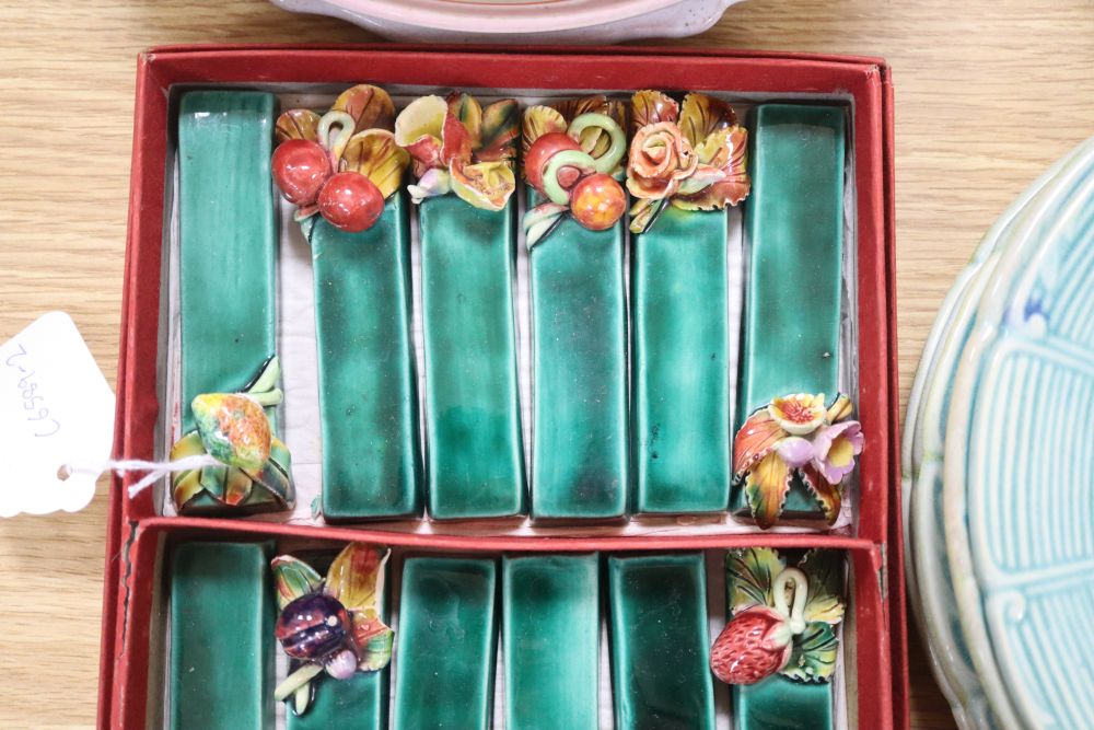 A set of six French earthenware plates, faience plates etc and pottery knife rests